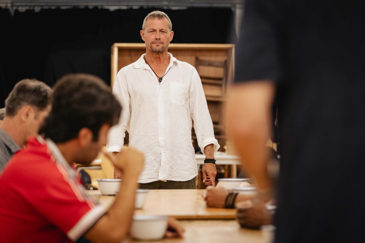 Bill Ward as Warden Stammas and the cast of The Shawshank Redemption in rehearsals - Photo by Mark Senior